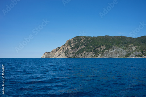 Italy, Cinque Terre, Monterosso, Monterosso al Mare, SCENIC VIEW OF SEA AGAINST CLEAR BLUE SKY © SkandaRamana