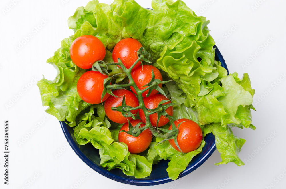 Top view of tomatoes and lettuce leaves in the bowl.Fresh and diet food for healthy life Top view of tomatoes and lettuce leaves in the bowl.Fresh and diet food for healthy life