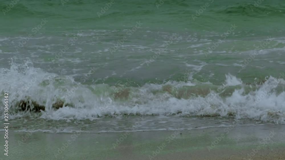 Rough sea with snow storm. Winter sea storm wave strikes the sandy coast. Coastal seascape Rough sea with snow storm. Winter sea storm wave strikes the sandy coast. Coastal seascape