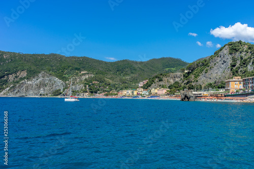 Italy, Cinque Terre, Monterosso, a large body of water with a mountain in the background