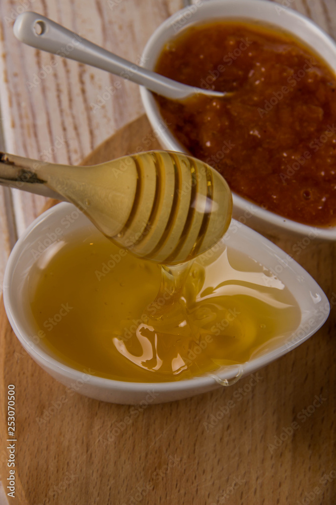 Sweets for pancakes in two bowls, honey and jam