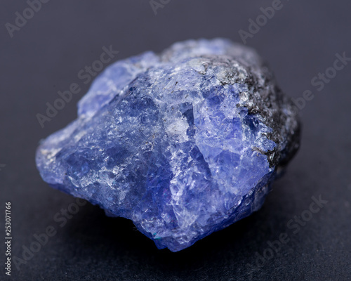 Soft blue violet rough TANZANITE from Tanzania isolated on black background. photo