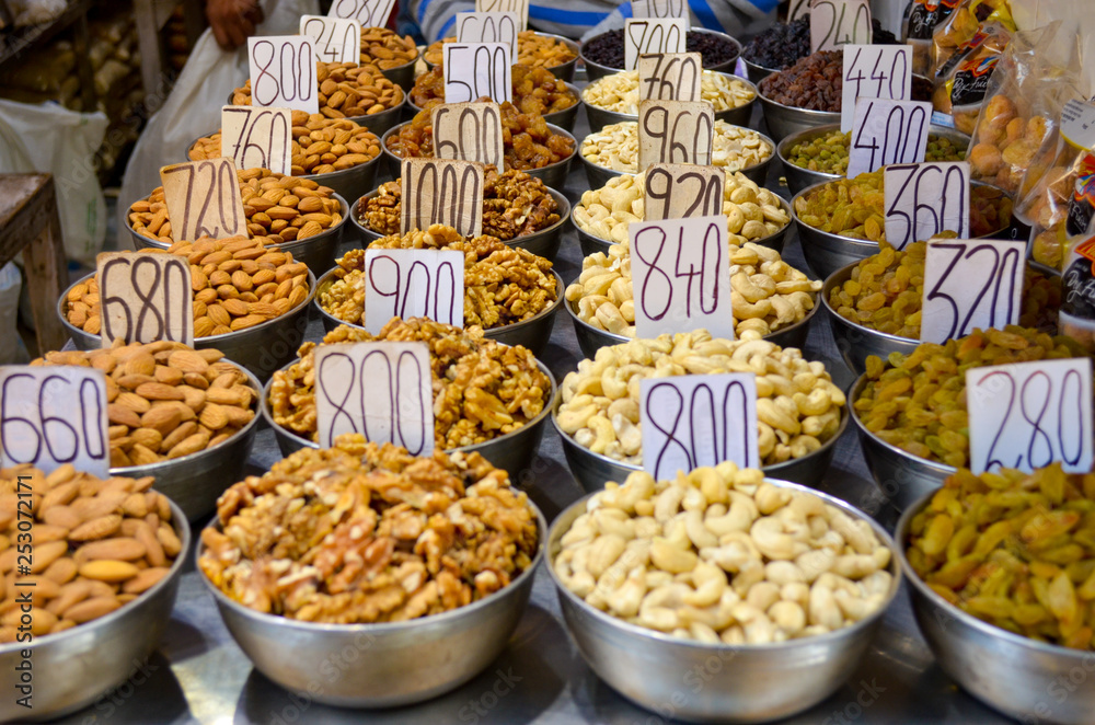 Top view of dry fruit samples nicely stacked placed in bowls and put on display in a shop in old Delhi spice market Khari Bouli, Chandni Chowk, Old Delhi, India