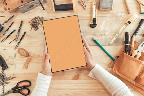 Female carpenter using digital tablet computer, mock up screen