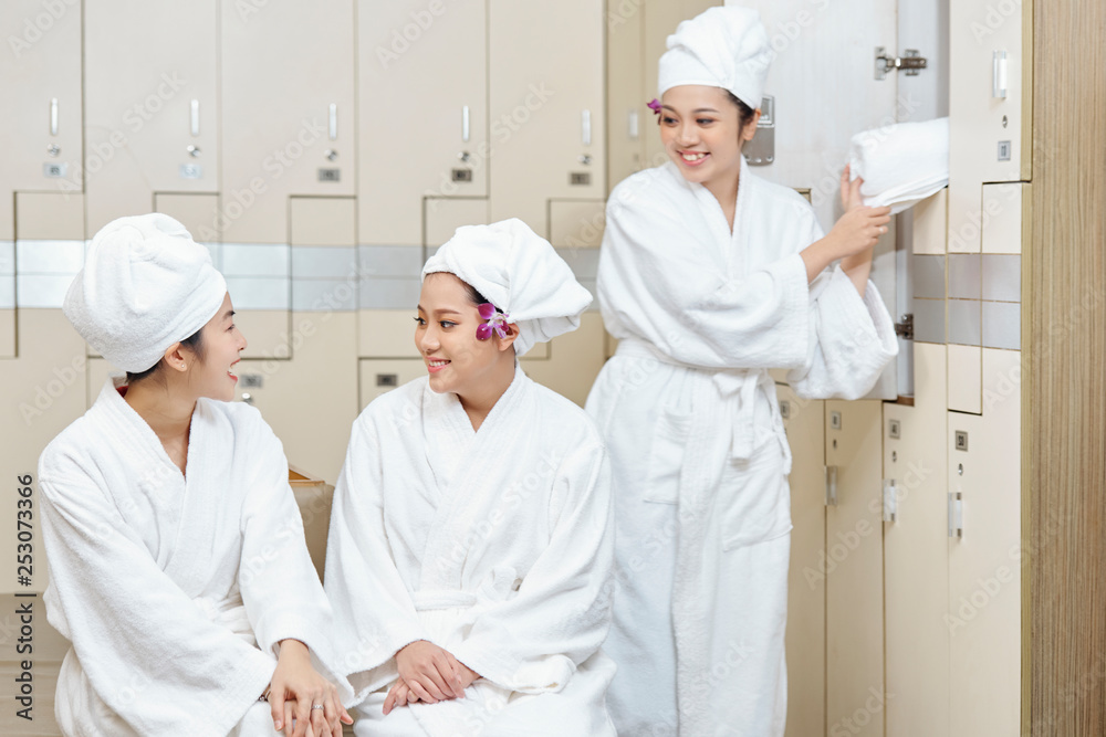 Asian women in dressing room of spa centre