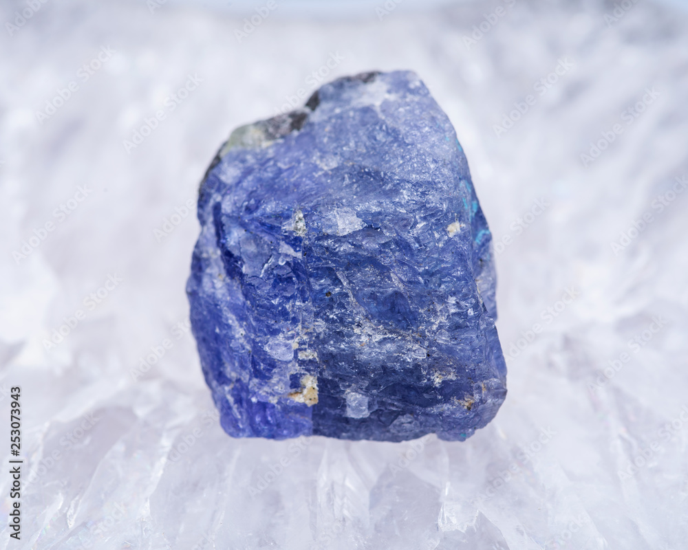 Soft blue violet rough TANZANITE from Tanzania placed on a crystalline druzy center of  Polished Large Natural Blue Lace Agate slab from Brazil.