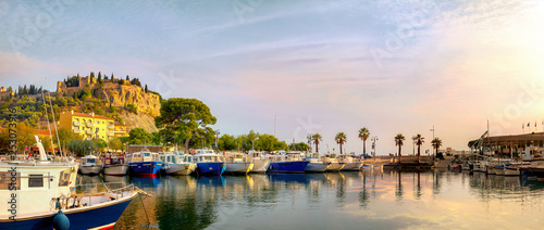 Panoramic landscape with fishing boats in harbour of Cassis at sunset sunlight. France, Provence photo