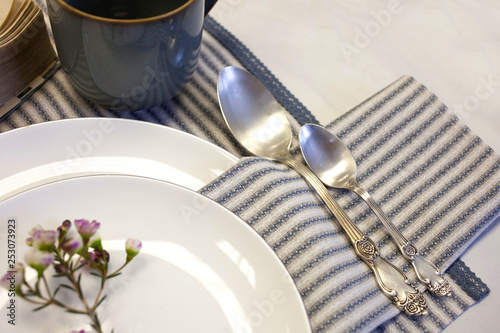 Simple table setting with white-blue linen napkins vintage style