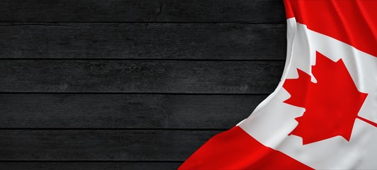Fototapete Kanada Flagge von Kanada, Stoff auf dunklem Holz.  © Negro Elkha