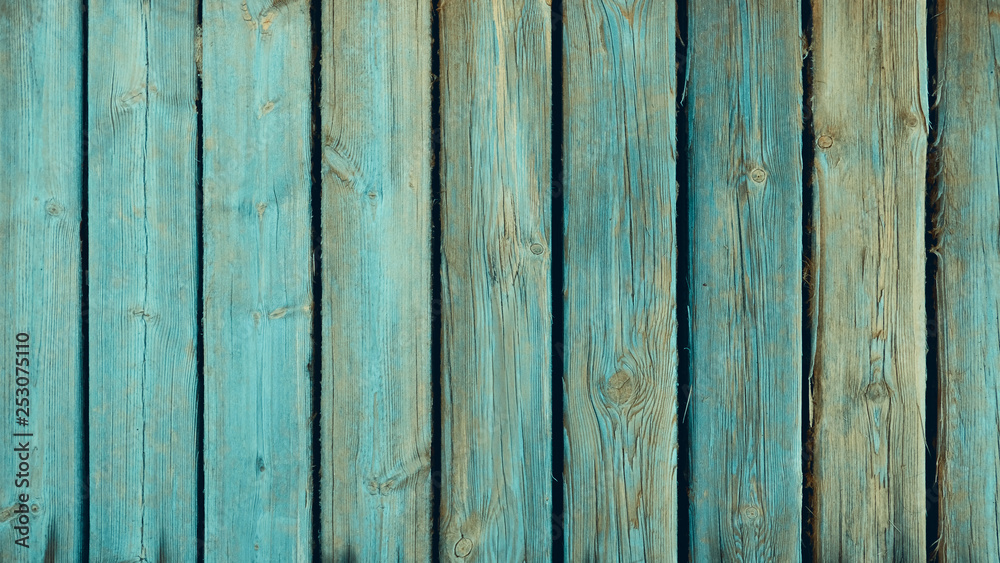 Old weathered and distressed wooden panels with traces of teal green paint, ligneous background with copy space, shabby wooden surface for natural texture backdrops Old weathered and distressed wooden panels with traces of teal green paint, ligneous background with copy space, shabby wooden surface for natural texture backdrops