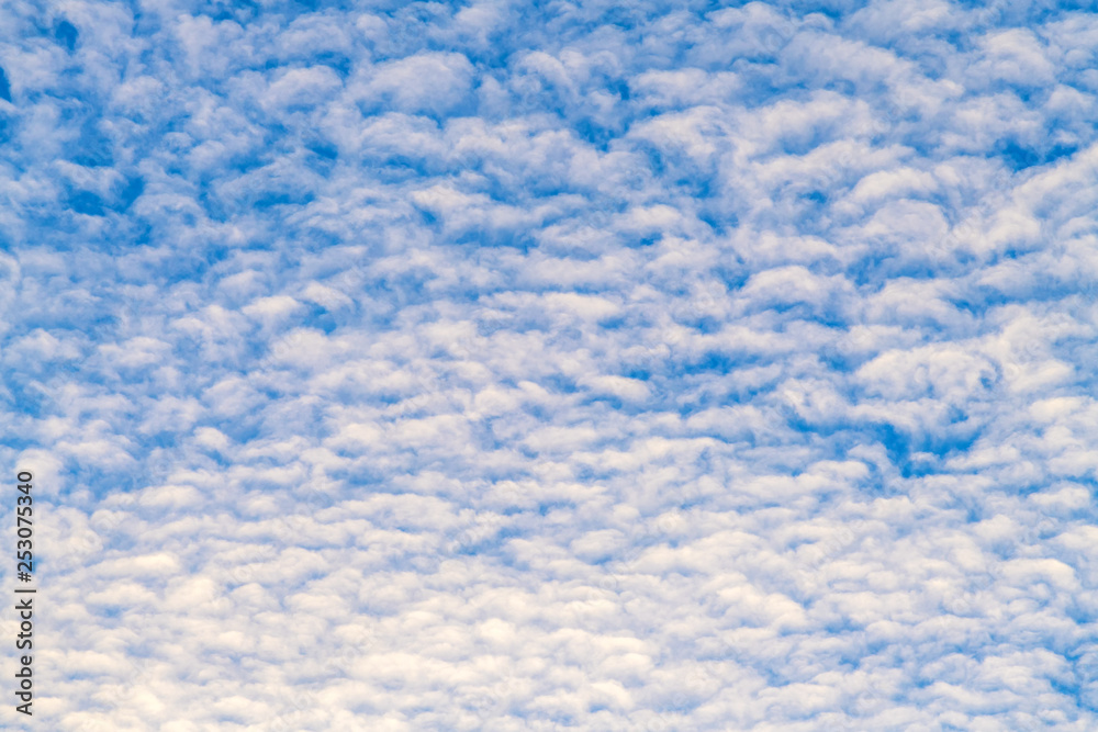White fluffy clouds on blue sky