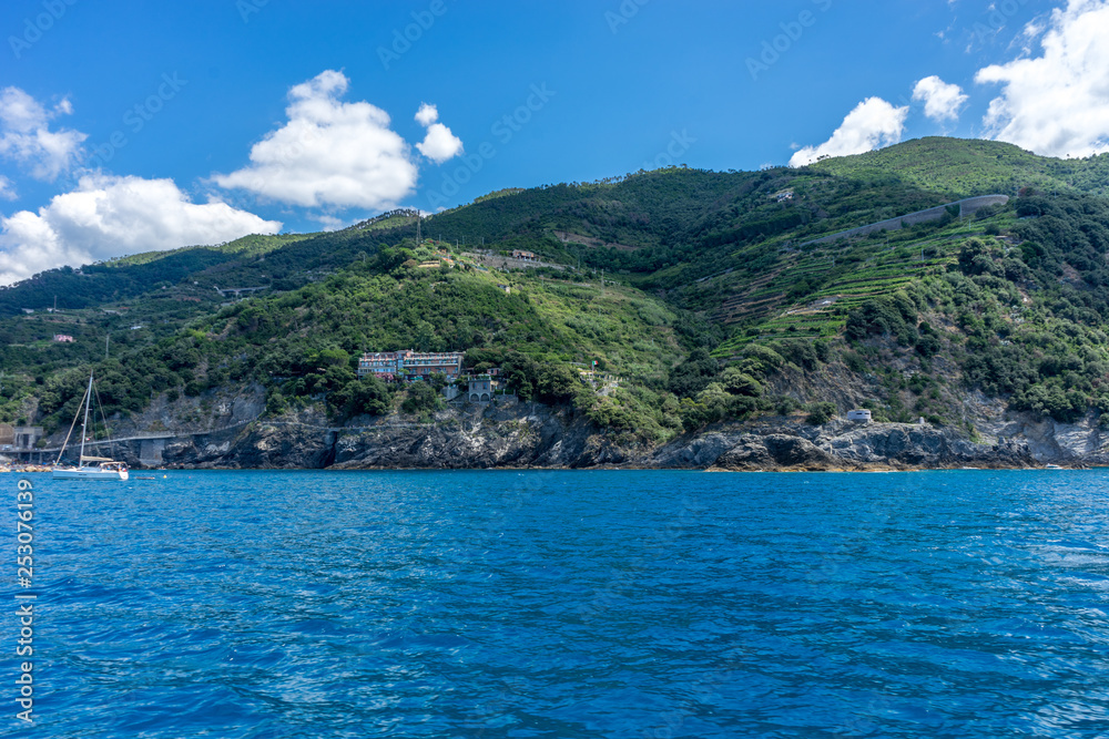 Italy, Cinque Terre, Monterosso, a large body of water with a mountain in the background