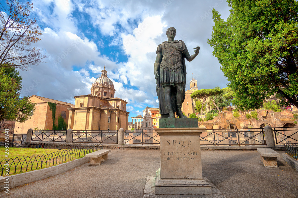Landscape with bronze statue of Caesar and view of Roman Forum in Rome. Italy