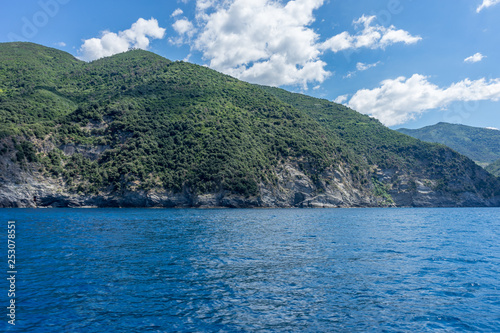 Italy, Cinque Terre, Monterosso, a large body of water with a mountain in the background