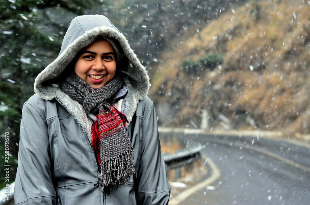 Young Indian woman enjoying her first snowfall during winter holidays in Kufri, Shimla, Himachal Pradesh. It is a popular winter getaway where people come to enjoy snowfall, skiing and winter sports Young Indian woman enjoying her first snowfall during winter holidays in Kufri, Shimla, Himachal Pradesh. It is a popular winter getaway where people come to enjoy snowfall, skiing and winter sports