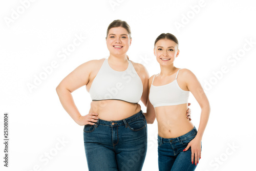 happy slim and overweight women hugging isolated on white, body positivity concept