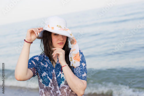 Beautiful girl in a hat on the background of the sea © Светлана Лазаренко