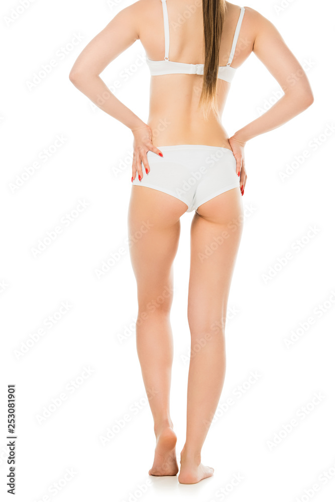 back view of sexy young woman in underwear posing with hands on hips isolated on white