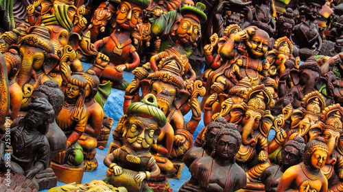 Miniature Hindu god statues (Ganesha, Shiva, Buddha) exhibited by a road vendor in South India