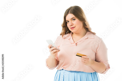 confident elegant plus size woman holding smartphone and credit card isolated on white