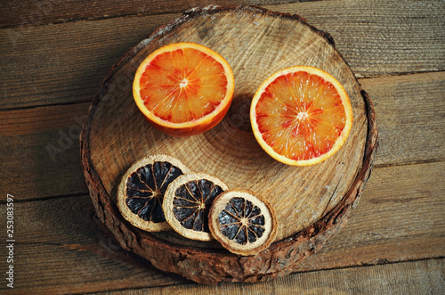 Juicy reddish tangerine on wood