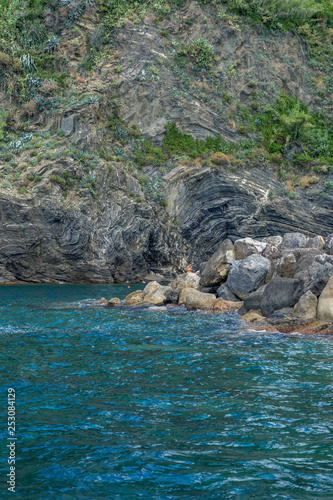 Italy, Cinque Terre, Monterosso, a close up of a rock next to a body of water