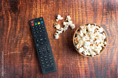 Salt popcorn on the wooden table. Popcorn in a wooden bowl.