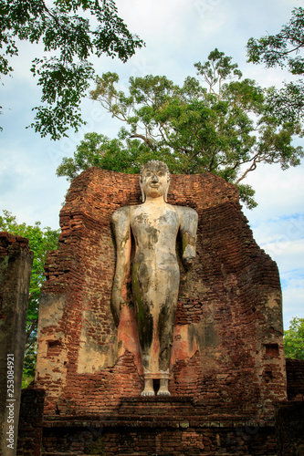 Big Buddha statue at the ruins in Kamphaeng Phet Historical Park In Thailand, Buddha statue, Old Town,Tourism, World Heritage Site, Civilization,UNESCO. photo