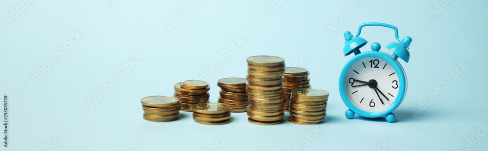 Time is money concept. Alarm clock and golden coins. Financial option of cash investment. Time is money concept. Alarm clock and golden coins. Financial option of cash investment.
