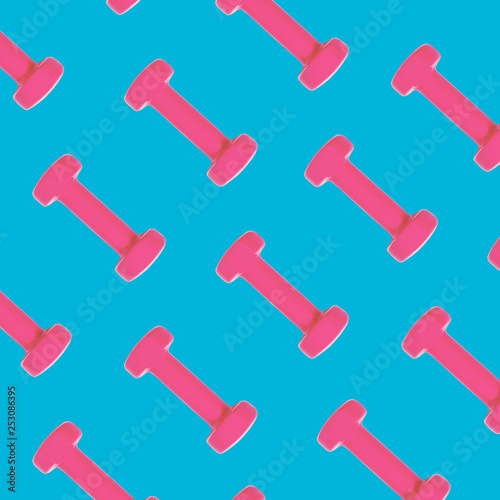 Pink dumbbell pattern on blue background with copy space. Creative layout for sport fitness equipment concept. Minimal style, flat lay, top view. Copy space