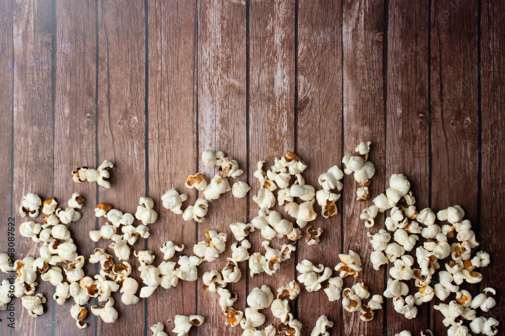 Fresh made Popcorn on an old and rustic wooden table