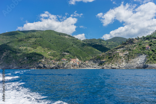 Italy, Cinque Terre, Monterosso, a large body of water with a mountain in the background