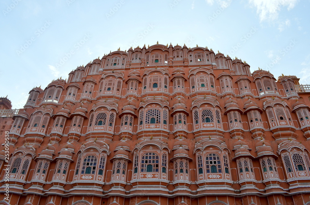 Low angle shot of facade of Hawa Mahal. Constructed with red and pink sandstone, the structure was built in 1799 by Maharaja Sawai Pratap Singh  in Jaipur, Rajasthan, India.