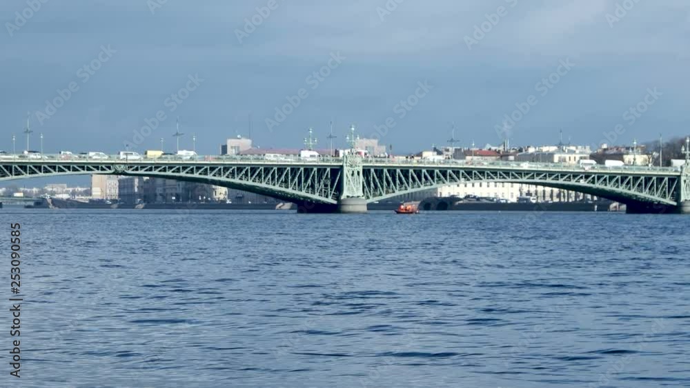 Rescuers and divers in an orange boat trying to save a suicide who wants to jump off the Trinity Bridge. Troitskiy Most. April 06, 2017. Saint-Peterburg, Russia. Rescuers and divers in an orange boat trying to save a suicide who wants to jump off the Trinity Bridge. Troitskiy Most. April 06, 2017. Saint-Peterburg, Russia.