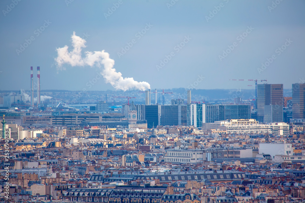 Smoking industrial pipes and Paris panoramic view Smoking industrial pipes and Paris panoramic view