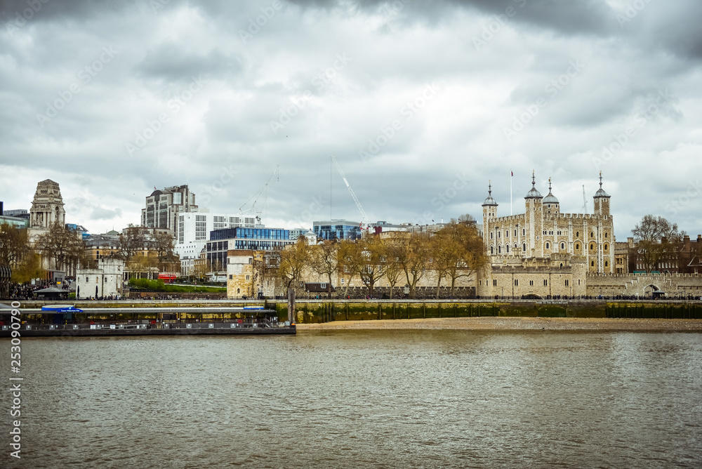 View of the Tower of London, a castle and a former prison in London, England, from the River Thames. The Tower of London, today a museum. 