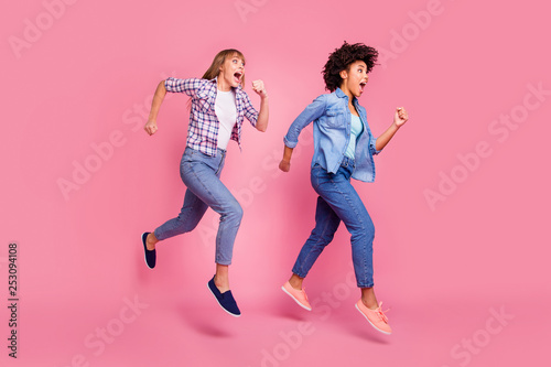 Full length body size view of two person nice-looking attractive charming cheerful funny girls running late fast competition isolated over pink pastel background