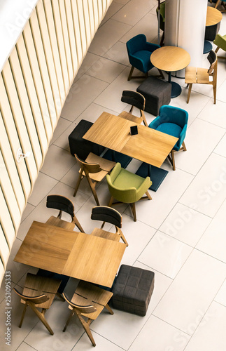 Tables and chairs in cafe. ontemporary design of bar furnishings. Coffee shop in a shopping center. photo