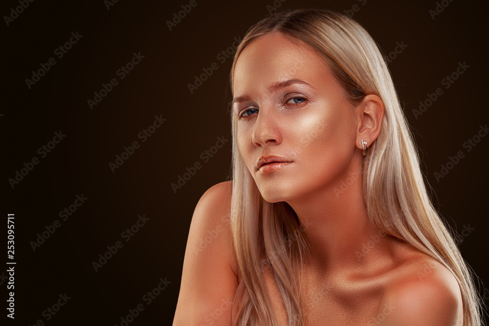 portrait of a girl. Golden shining makeup on the dark background portrait of a girl. Golden shining makeup on the dark background