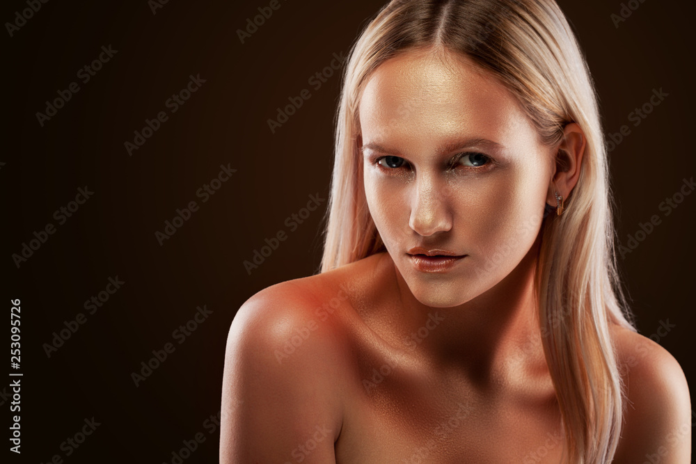 portrait of a girl. Golden shining makeup on the dark background portrait of a girl. Golden shining makeup on the dark background