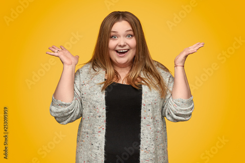 Excited plump woman gesturing with hands