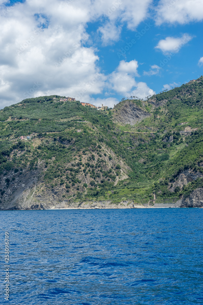 Italy, Cinque Terre, Monterosso, a large body of water with a mountain in the background