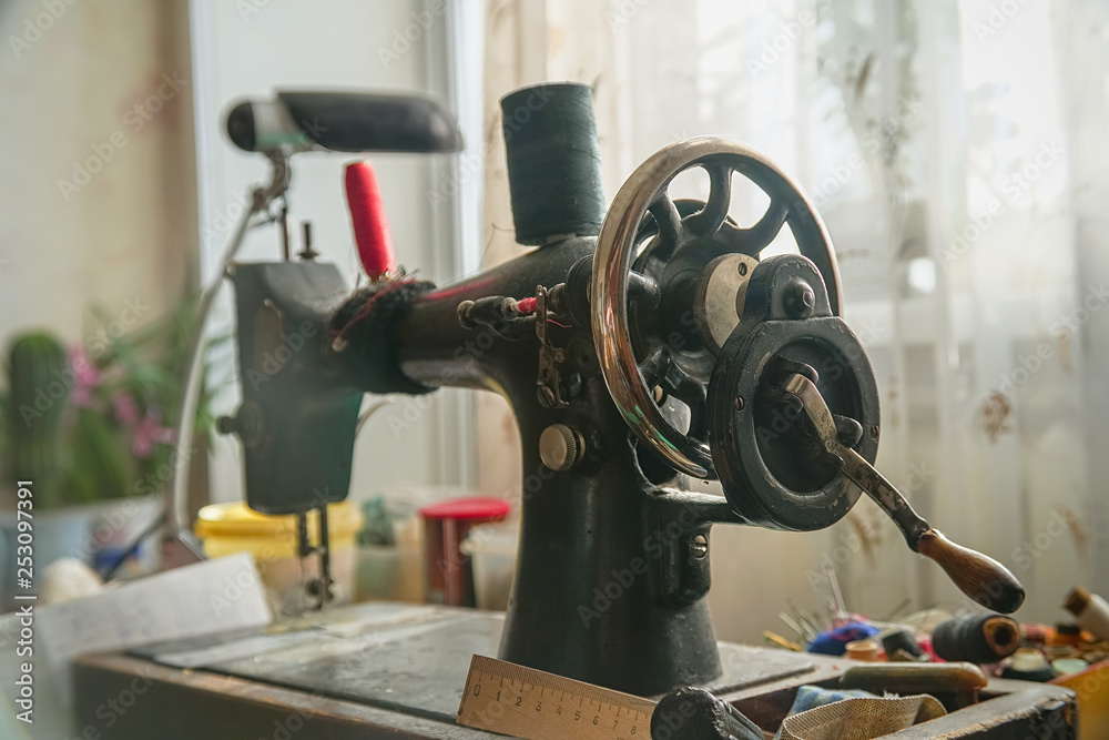 Fototapeta premium Old mechanical sewing machine on table