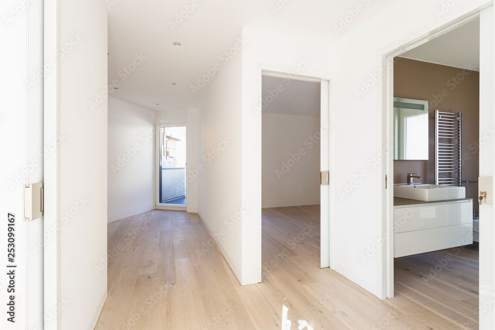 Corridor with open room doors and modern bathroom
