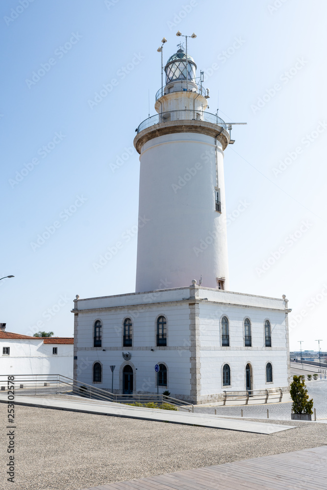 Lighthouse of the port of Malaga on a sunny day. Andalucia, Spain