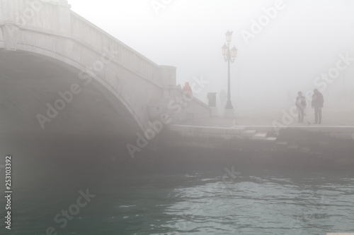 street and canal in venice in the fog