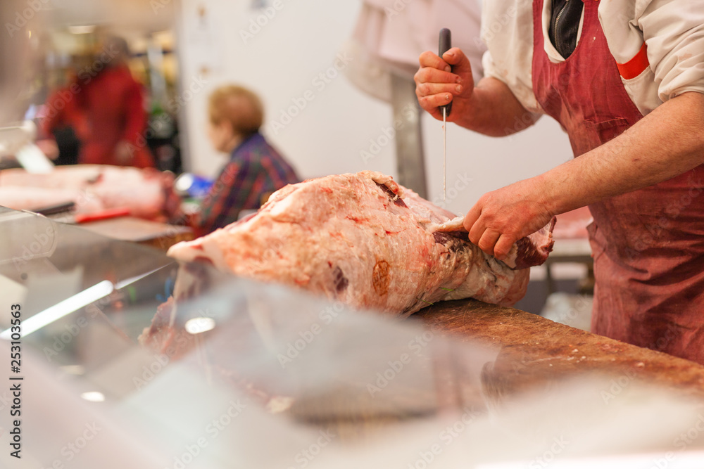 butcher sells chopped beef meat at a market