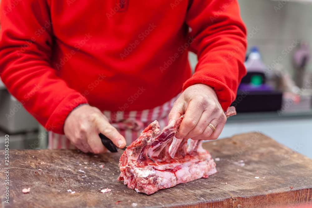 butcher cuts meat on the street market