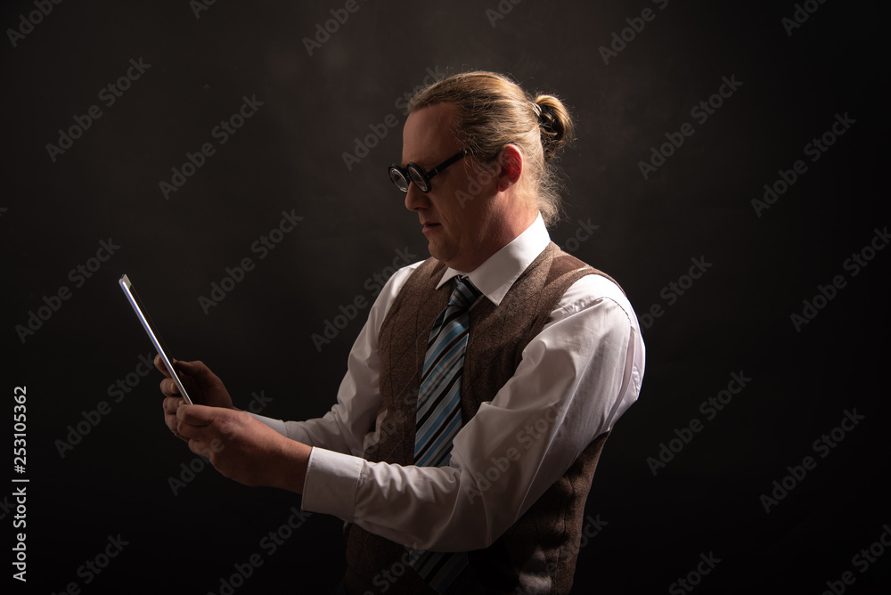 Funny nerd or geek looking on tablet with empty placeholder Funny nerd or geek looking on tablet with empty placeholder