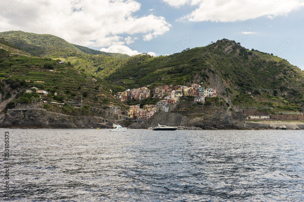 Italy, Cinque Terre, Monterosso, a large body of water with a mountain in the background
